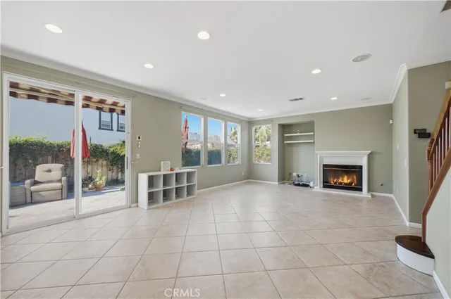 a view of an empty room with a fireplace and a window