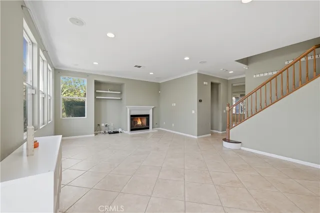 a view of an empty room with a fireplace and a window