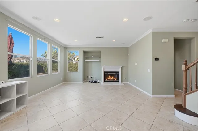 a view of an empty room with a fireplace and a window