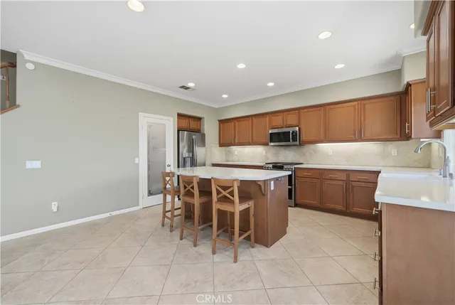 a kitchen with a sink and chairs