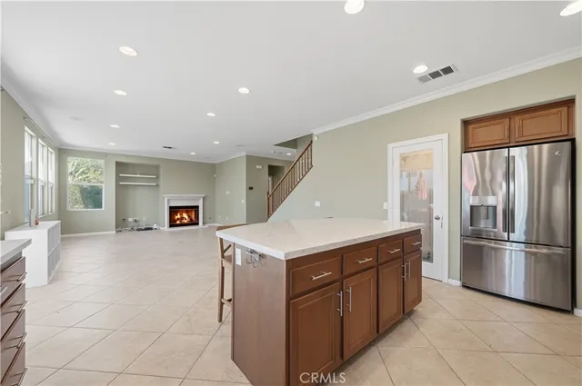 a kitchen with a sink refrigerator and microwave