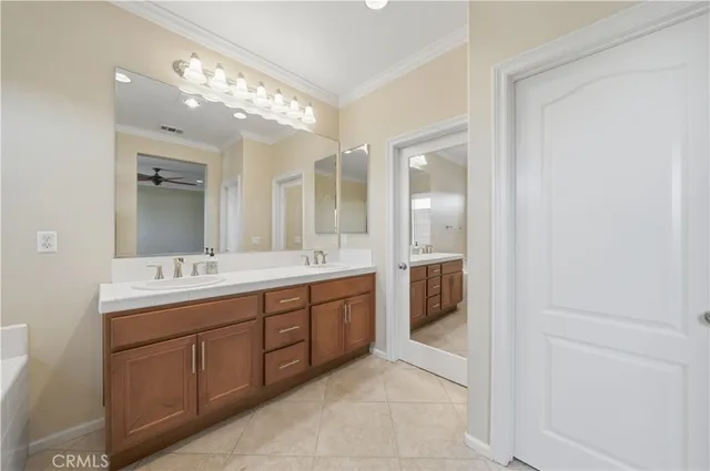 a spacious bathroom with a double vanity sink and mirror