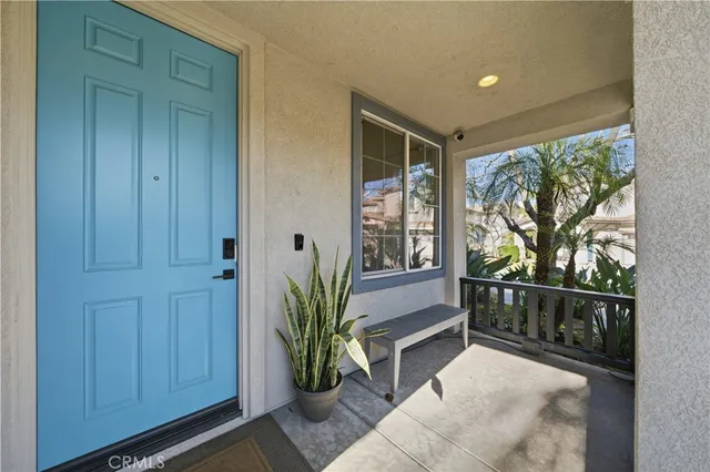 a view of entryway with wooden floor and front door