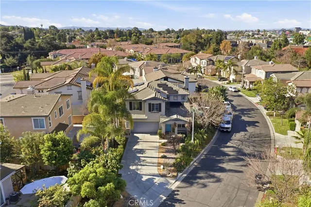 an aerial view of a house with a yard