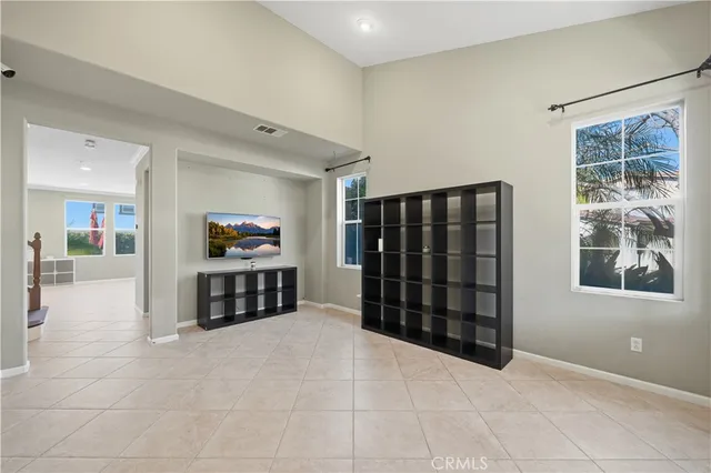 a view of an empty room with window and cabinet