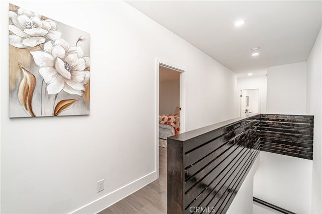 a dining room with wooden floor and white walls