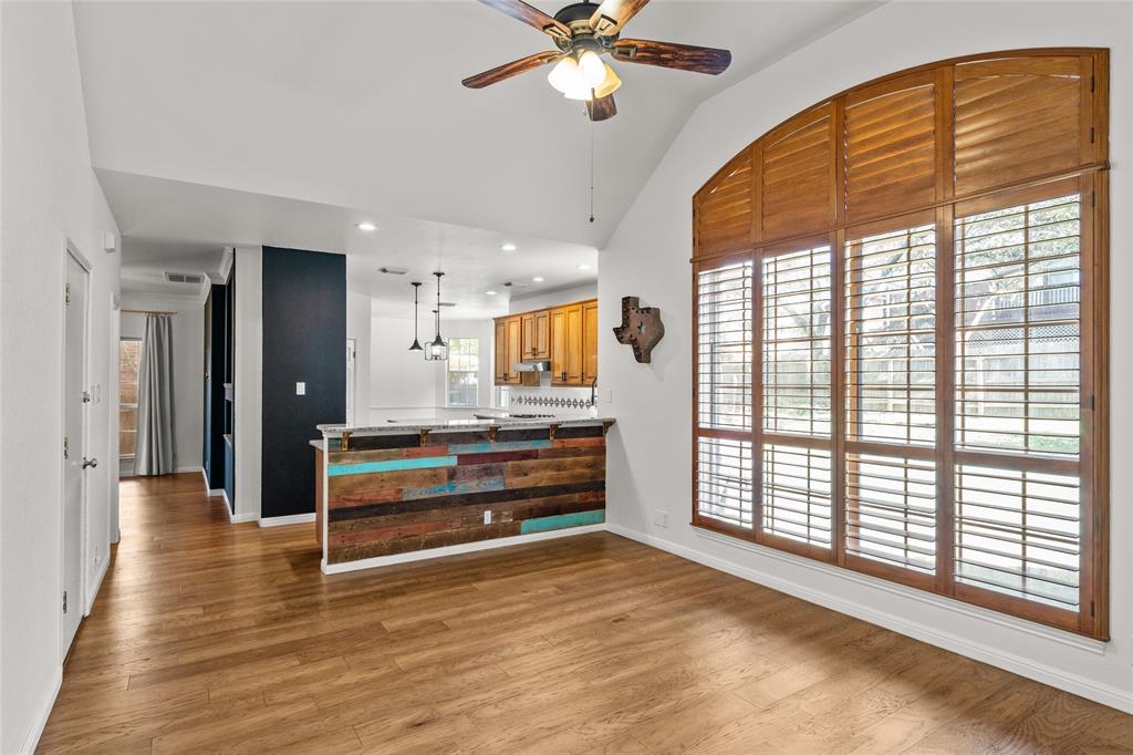 3901 Caney Creek Road Austin, TX 78732 - Photo 7 of 18 Additional space at the bar separating the kitchen and family room. Half bath is to the left of the bar.