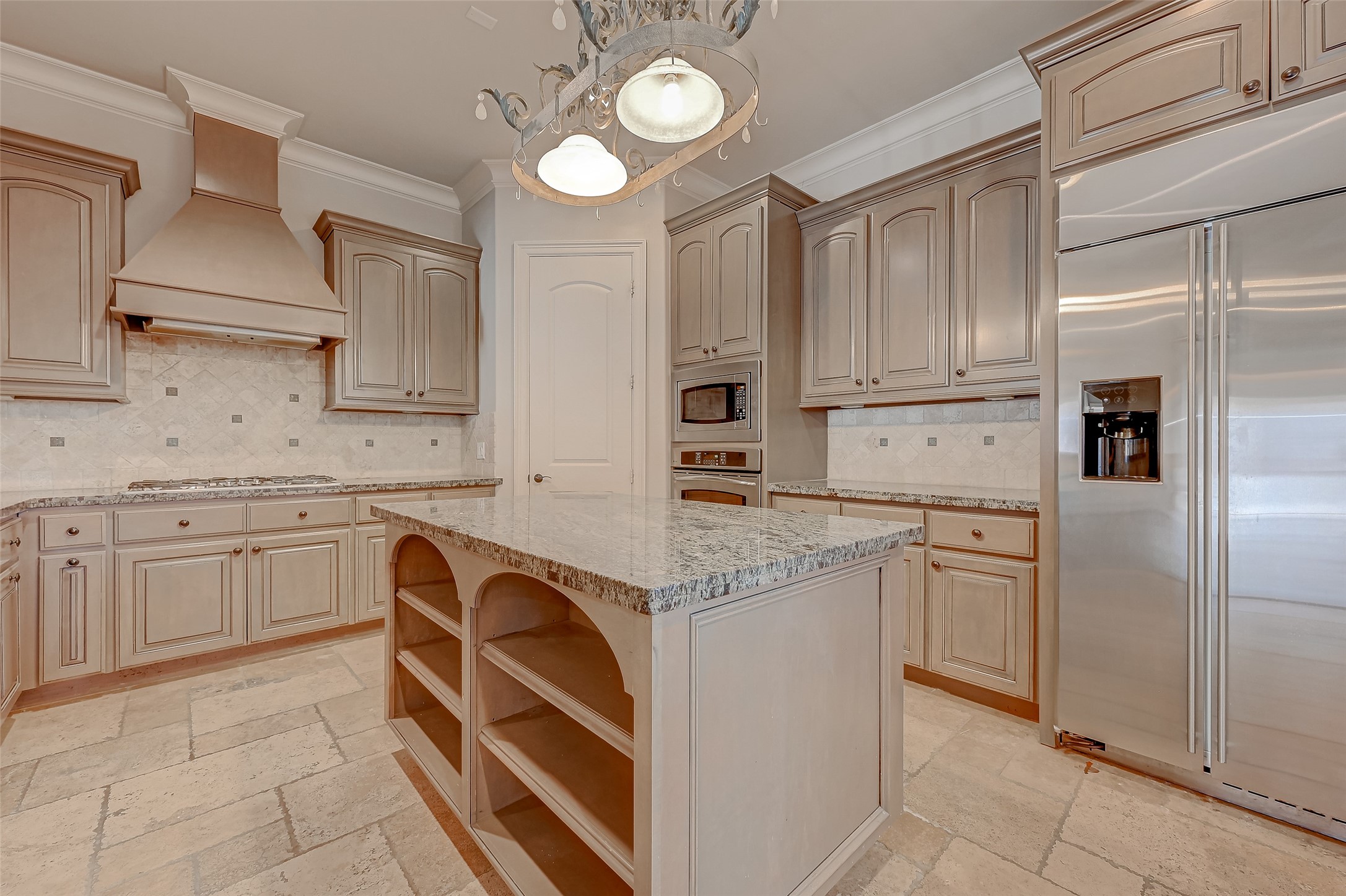 7619 Pine Ridge Terrace Road Houston, TX 77081 - Photo 11 of 32 a kitchen with stainless steel appliances granite countertop a stove a sink and a refrigerator