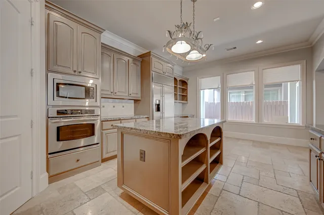 a kitchen with stainless steel appliances granite countertop a stove and cabinets