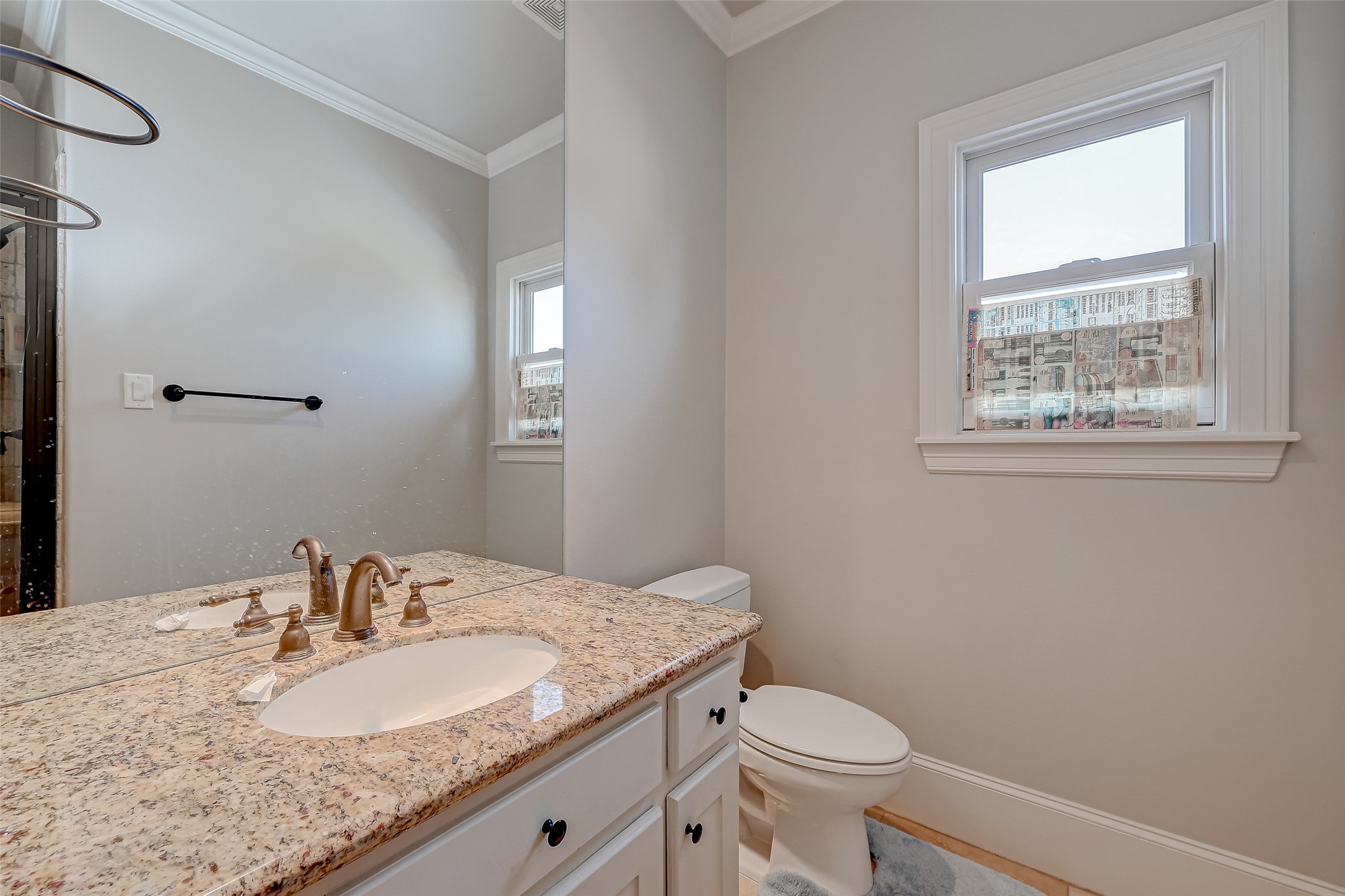 7619 Pine Ridge Terrace Road Houston, TX 77081 - Photo 17 of 32 a bathroom with a granite countertop sink toilet and mirror