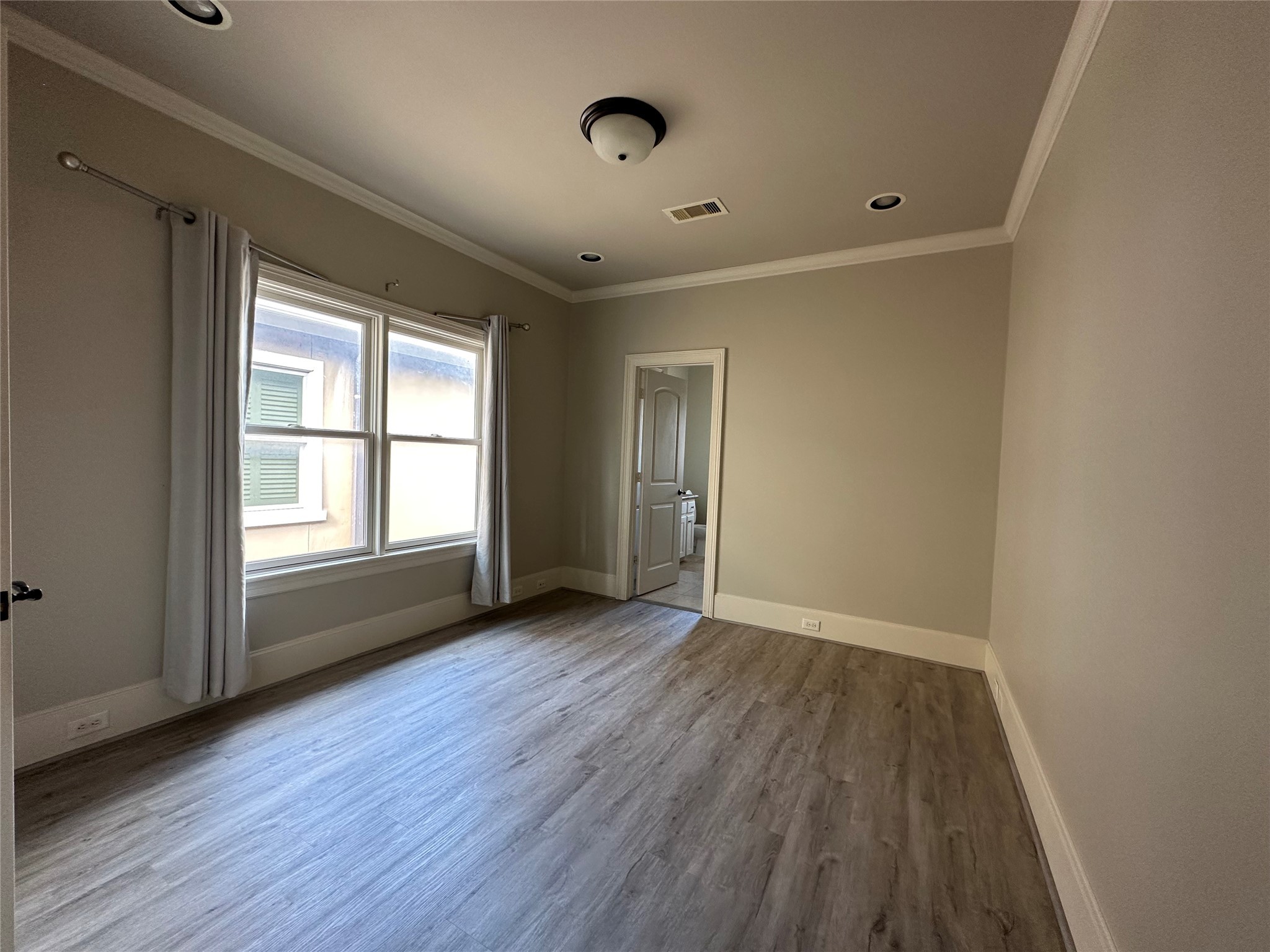 7619 Pine Ridge Terrace Road Houston, TX 77081 - Photo 18 of 32 an empty room with wooden floor and windows
