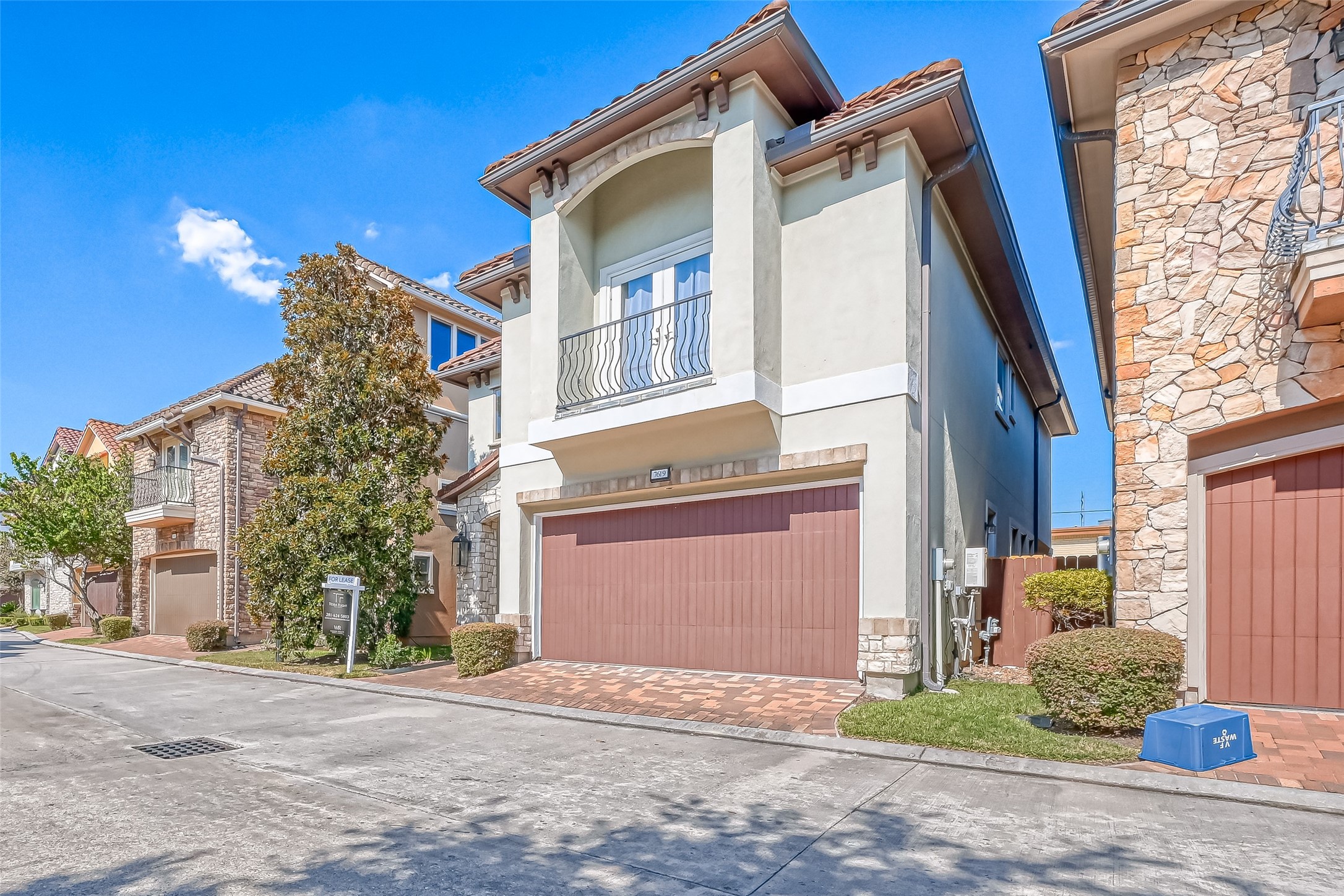 7619 Pine Ridge Terrace Road Houston, TX 77081 - Photo 2 of 32 a front view of a house with a yard and garage