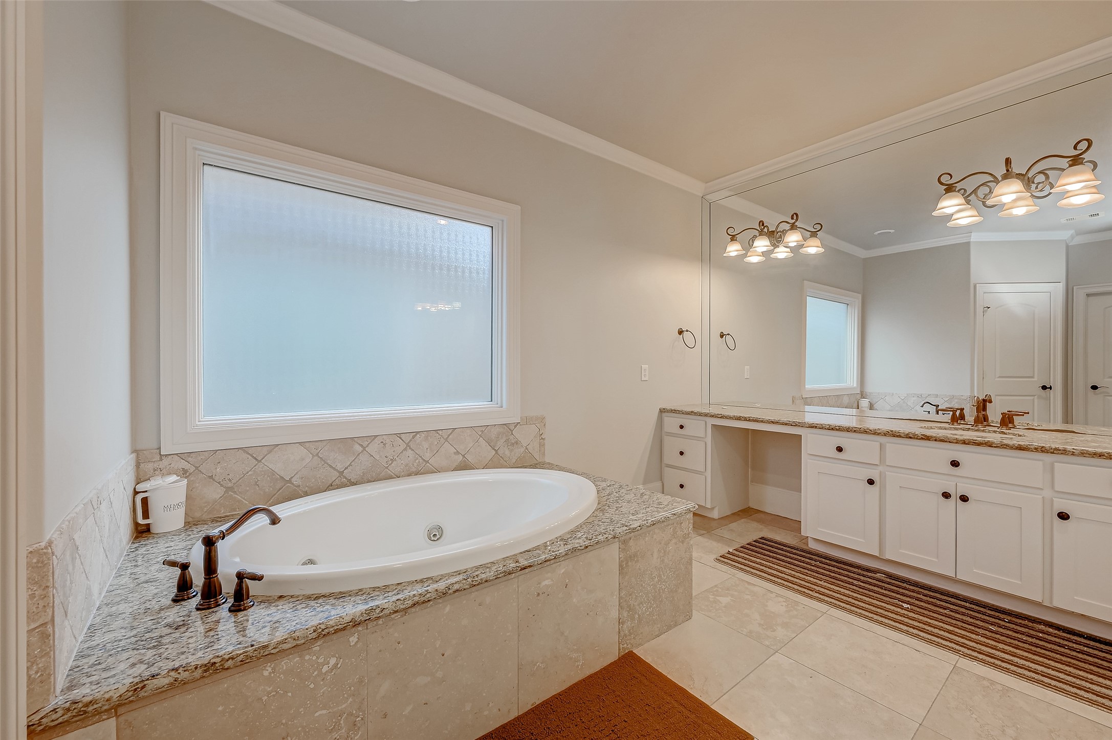 7619 Pine Ridge Terrace Road Houston, TX 77081 - Photo 23 of 32 a bathroom with a tub sink and mirror
