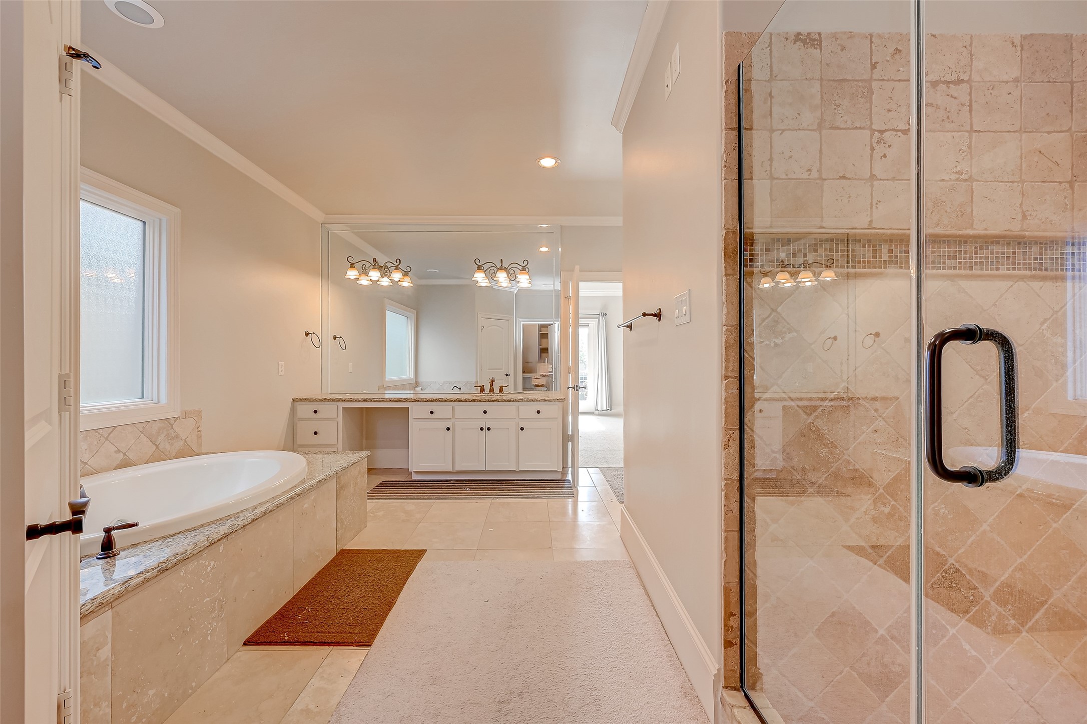 7619 Pine Ridge Terrace Road Houston, TX 77081 - Photo 24 of 32 a bathroom with a tub sink shower and mirror