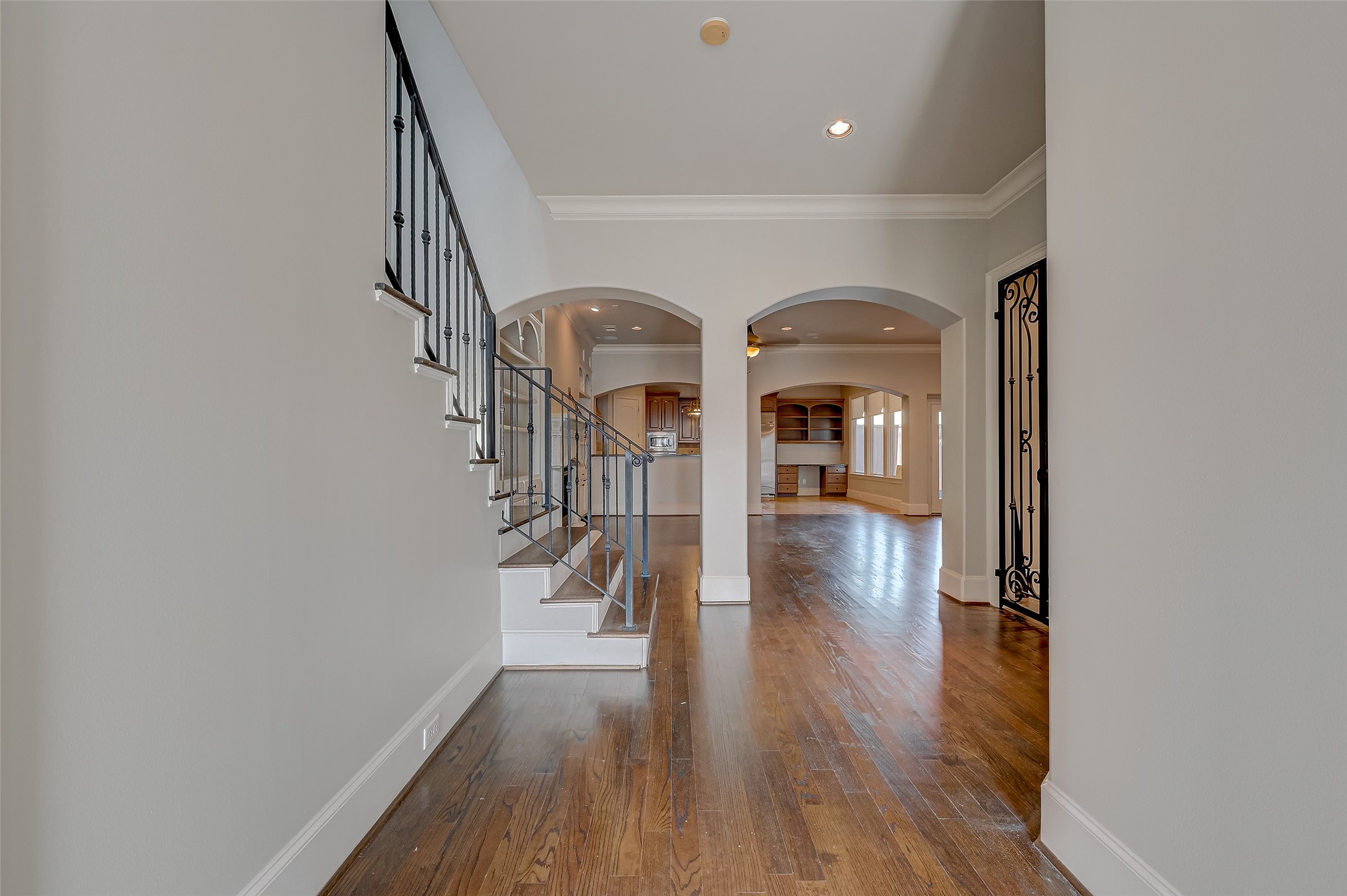 7619 Pine Ridge Terrace Road Houston, TX 77081 - Photo 3 of 32 a hallway with wooden floor staircase and a hallway
