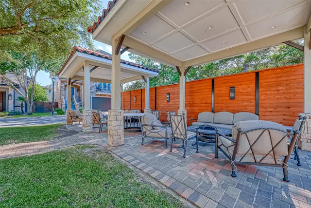a view of a patio with table and chairs under an umbrella