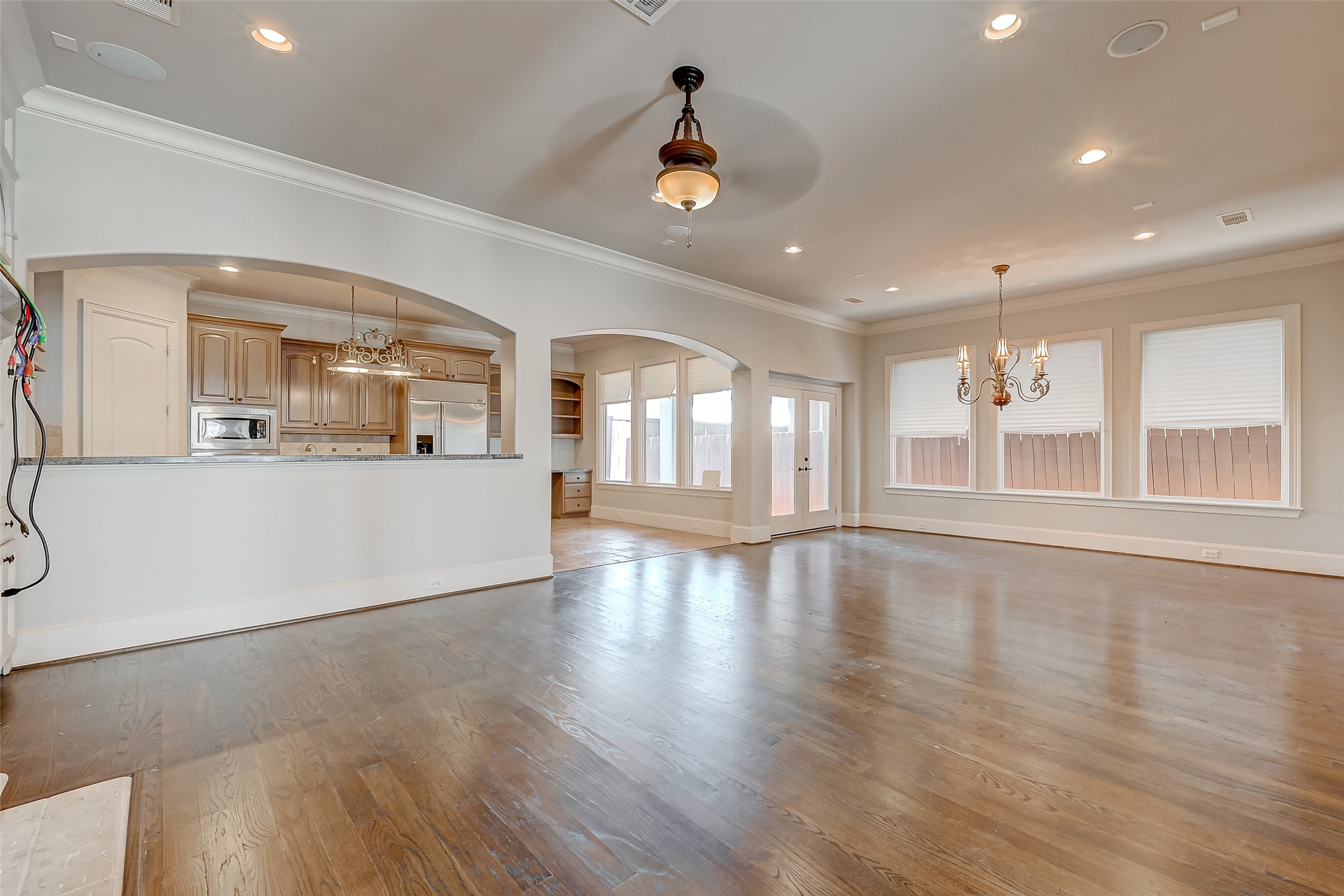 7619 Pine Ridge Terrace Road Houston, TX 77081 - Photo 5 of 32 a view of an empty room with wooden floor and a window