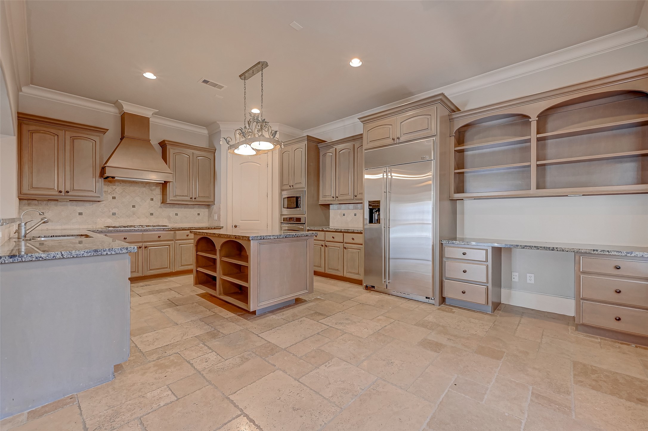 7619 Pine Ridge Terrace Road Houston, TX 77081 - Photo 9 of 32 a large kitchen with stainless steel appliances a stove a sink and a refrigerator