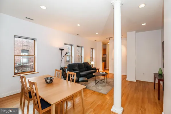 a living room with furniture and wooden floor