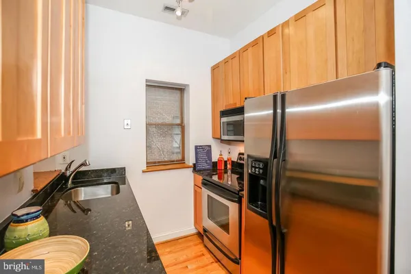 a kitchen with a refrigerator and a sink