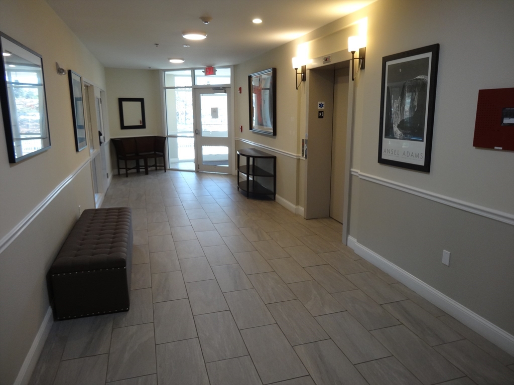 2 Inwood Drive, Unit 1005 Woburn, MA 01801 - Photo 2 of 8 a living room with furniture and a fireplace