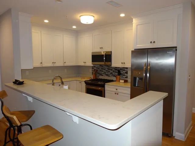 a kitchen that has a sink and a stove in it