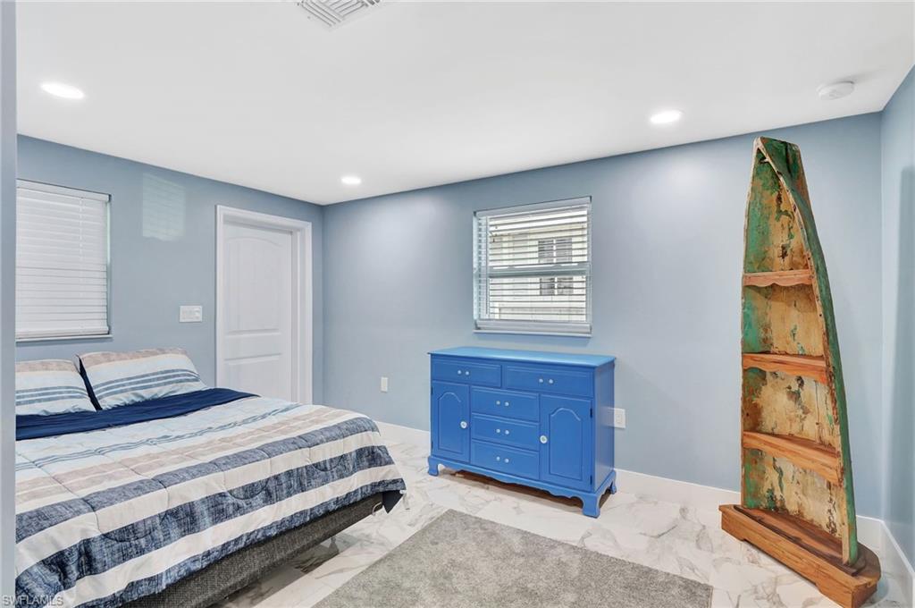 1009 Ridge Street Naples, FL 34103 - Photo 20 of 30 Bedroom with recessed lighting and light marble finish floors