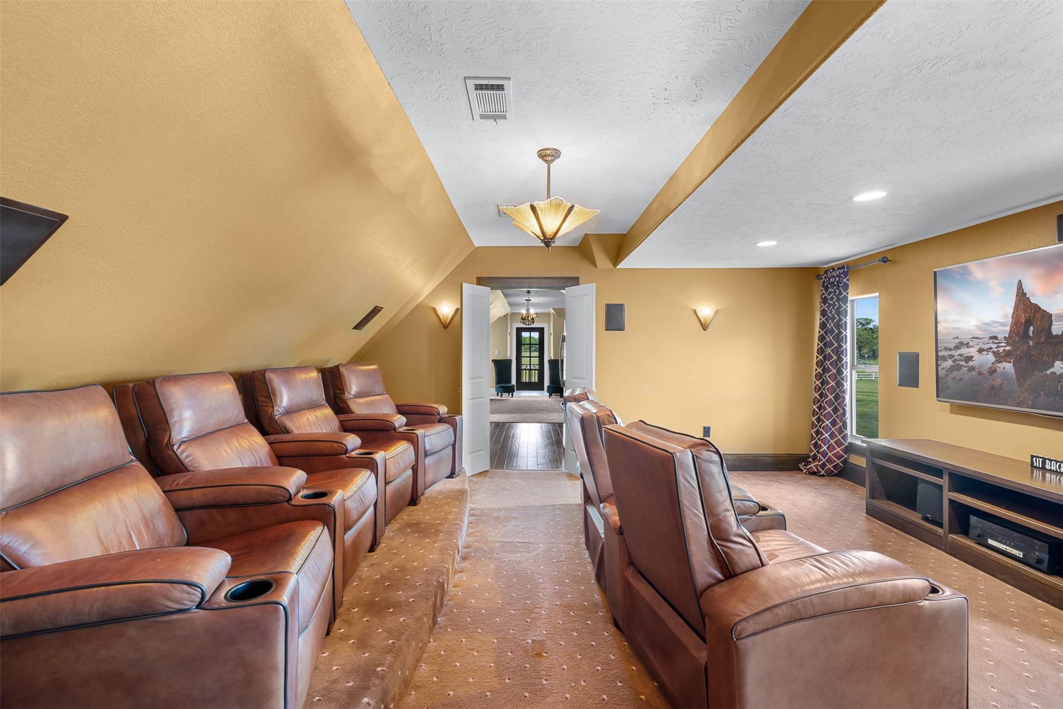 29500 Skymac Ranch Road Hempstead, TX 77445 - Photo 36 of 50 a living room with furniture a chandelier and a flat screen tv