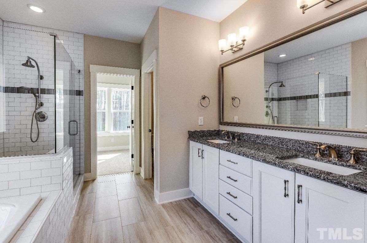 1416 Baileys Run Court Raleigh, NC 27606 - Photo 14 of 21 Dual vanity with granite counters and undermount sinks. Framed mirror and upgraded lighting.