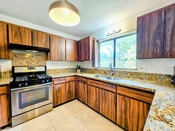 a kitchen with a sink window and cabinets