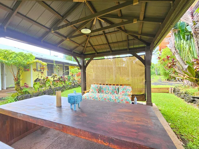 a view of a house with garden and trees