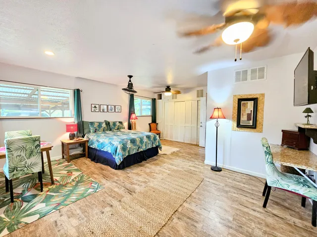 a bedroom with a bed and ceiling fan