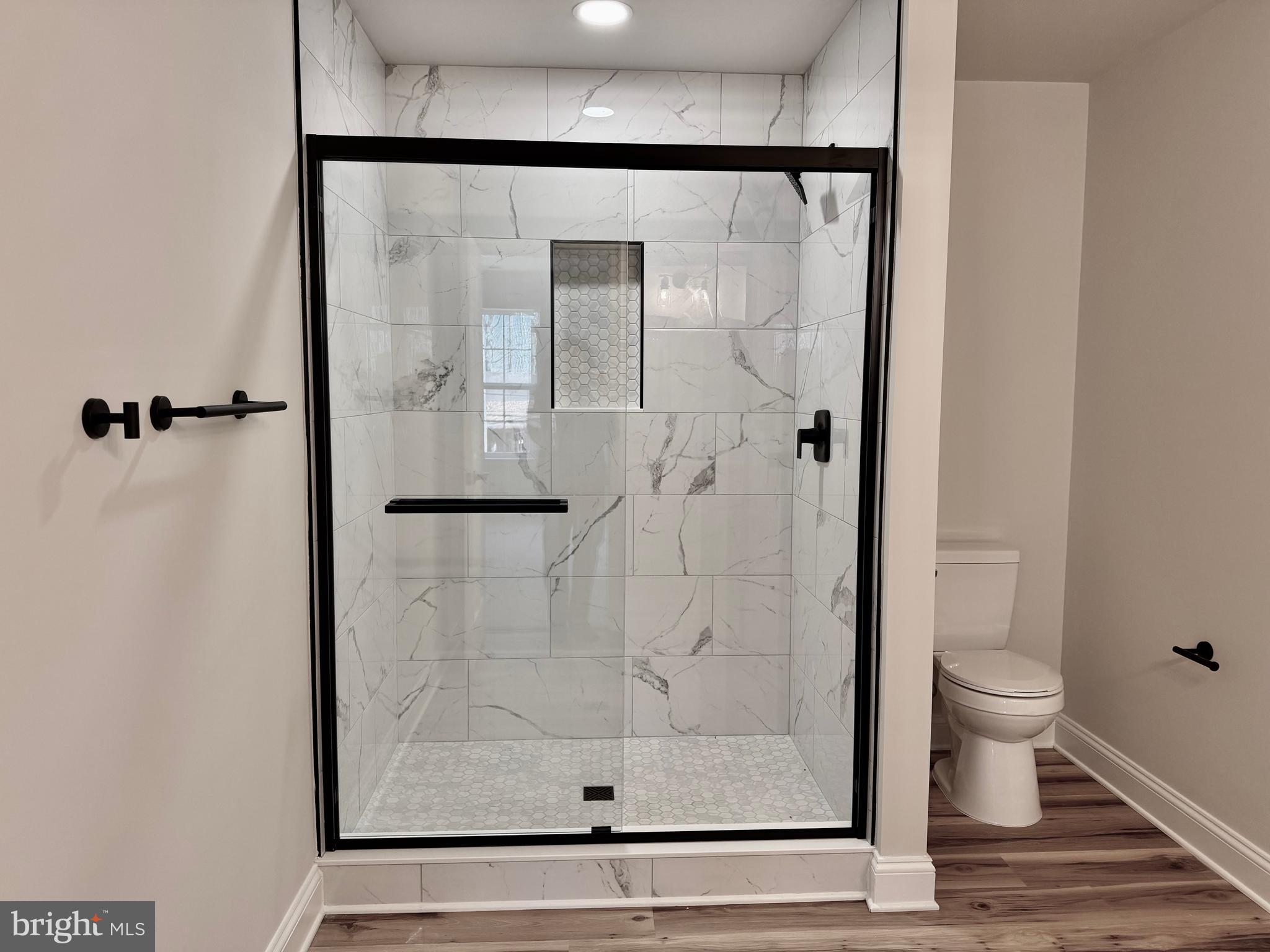 613 Santa Fe Trail Lusby, MD 20657 - Photo 17 of 24 a bathroom with a glass shower door