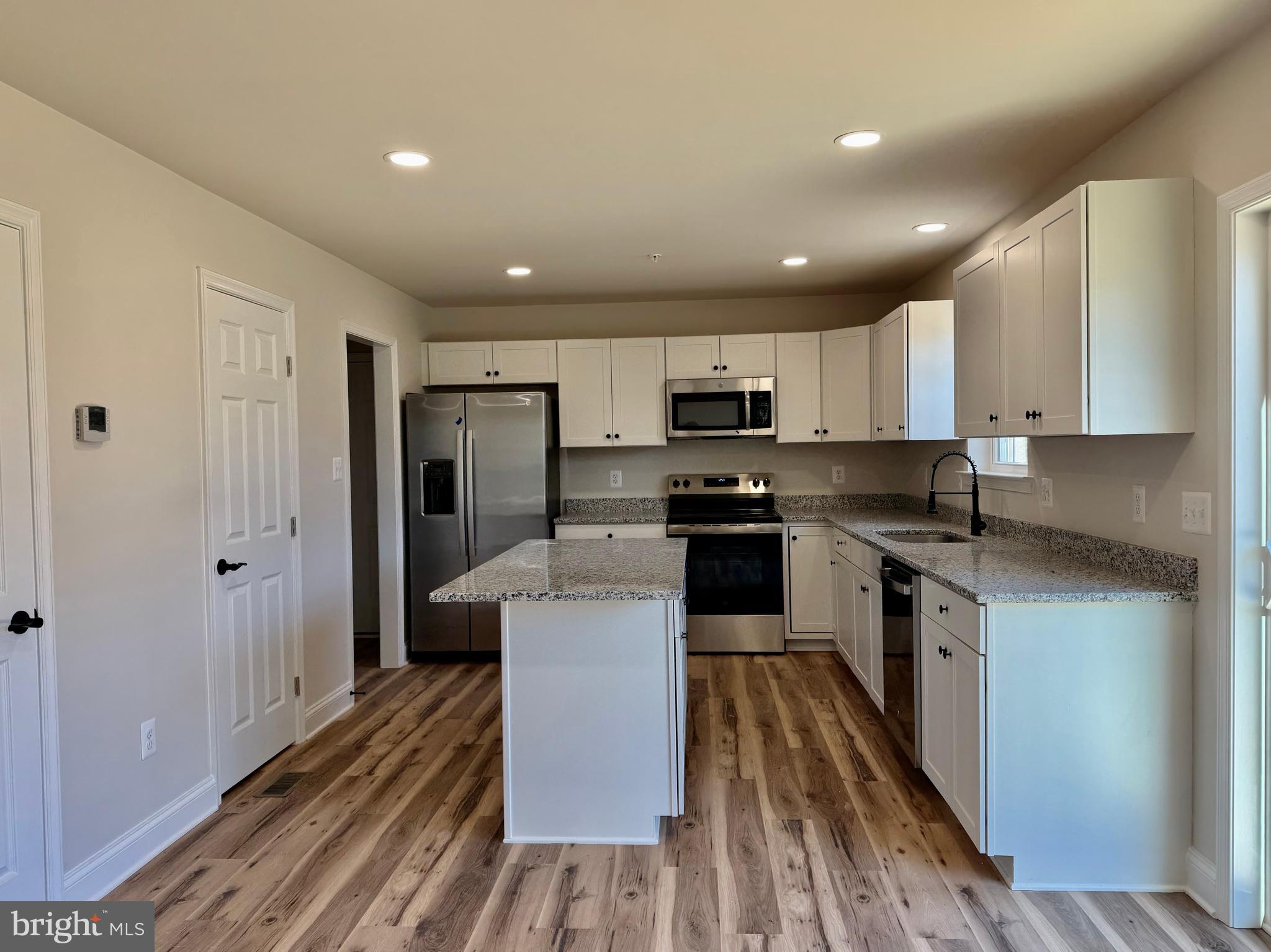 613 Santa Fe Trail Lusby, MD 20657 - Photo 4 of 24 a kitchen with stainless steel appliances granite countertop a refrigerator a stove top oven a sink and dishwasher