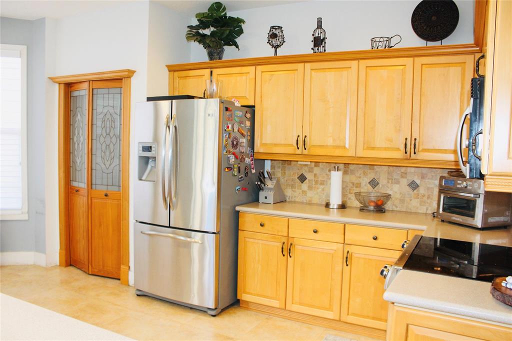 1512 Southwest 187th Terrace Pembroke Pines, FL 33029 - Photo 11 of 29 a kitchen with stainless steel appliances granite countertop a refrigerator and a stove top oven