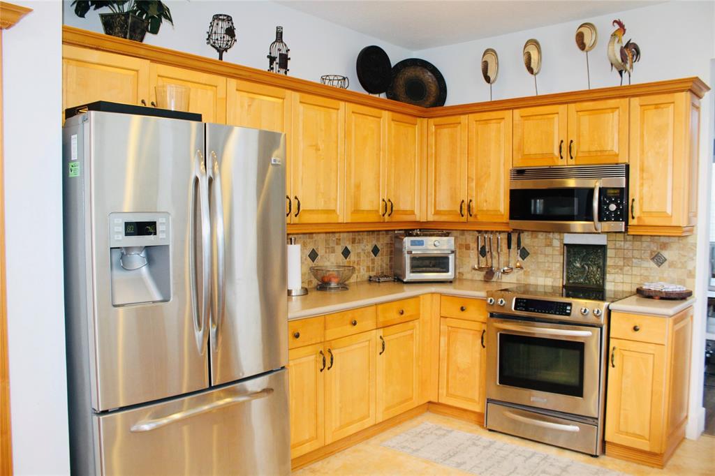 1512 Southwest 187th Terrace Pembroke Pines, FL 33029 - Photo 13 of 29 a kitchen with stainless steel appliances a refrigerator sink and microwave