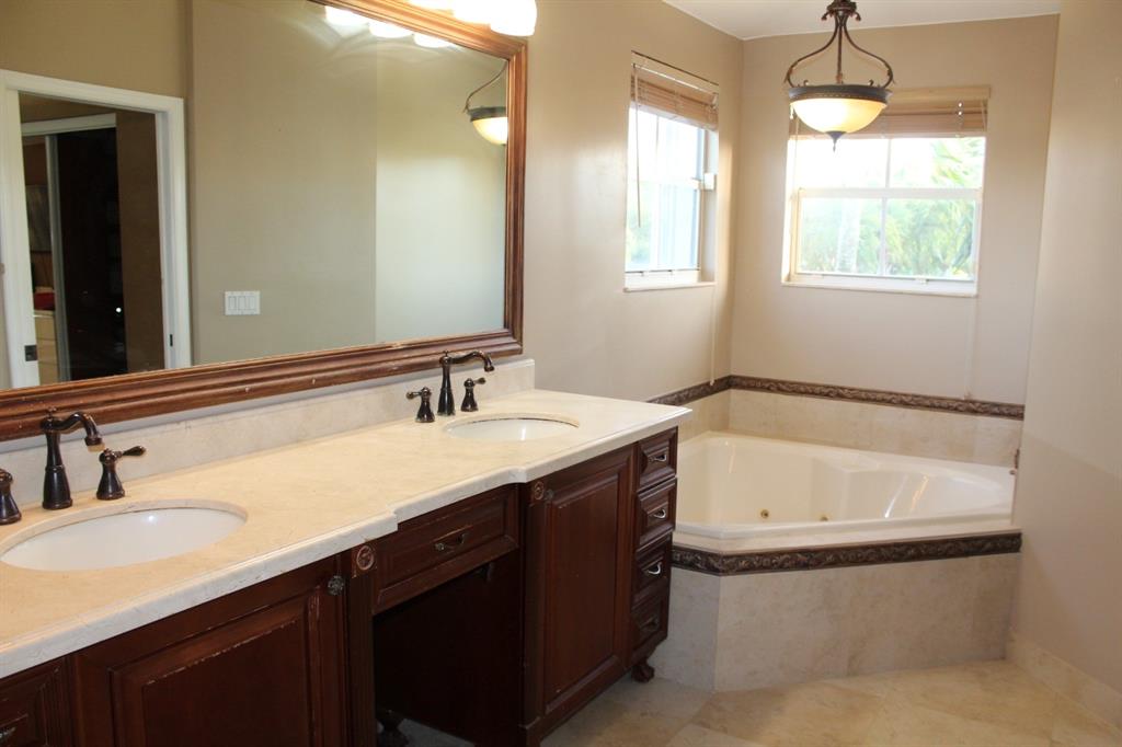 1512 Southwest 187th Terrace Pembroke Pines, FL 33029 - Photo 16 of 29 a bathroom with a tub sink and mirror