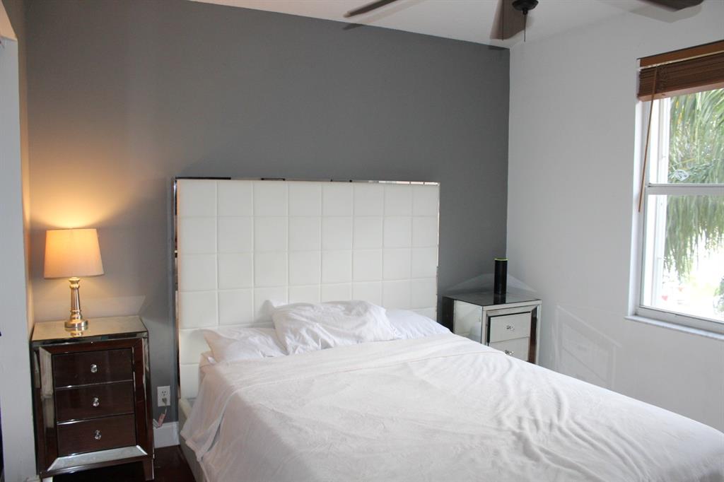 1512 Southwest 187th Terrace Pembroke Pines, FL 33029 - Photo 17 of 29 a bedroom with a bed and a lamp