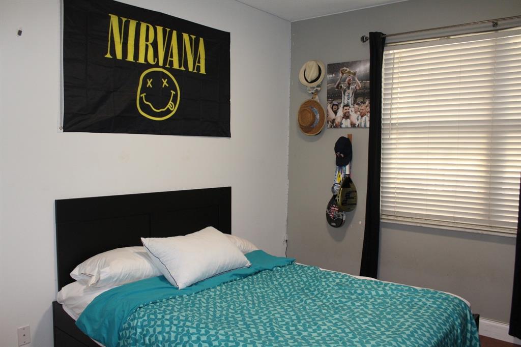 1512 Southwest 187th Terrace Pembroke Pines, FL 33029 - Photo 18 of 29 a bedroom with a bed and a wall painting