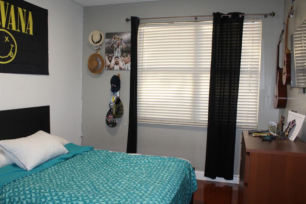 1512 Southwest 187th Terrace Pembroke Pines, FL 33029 - Photo 19 of 29 a bedroom with a bed and cabinets