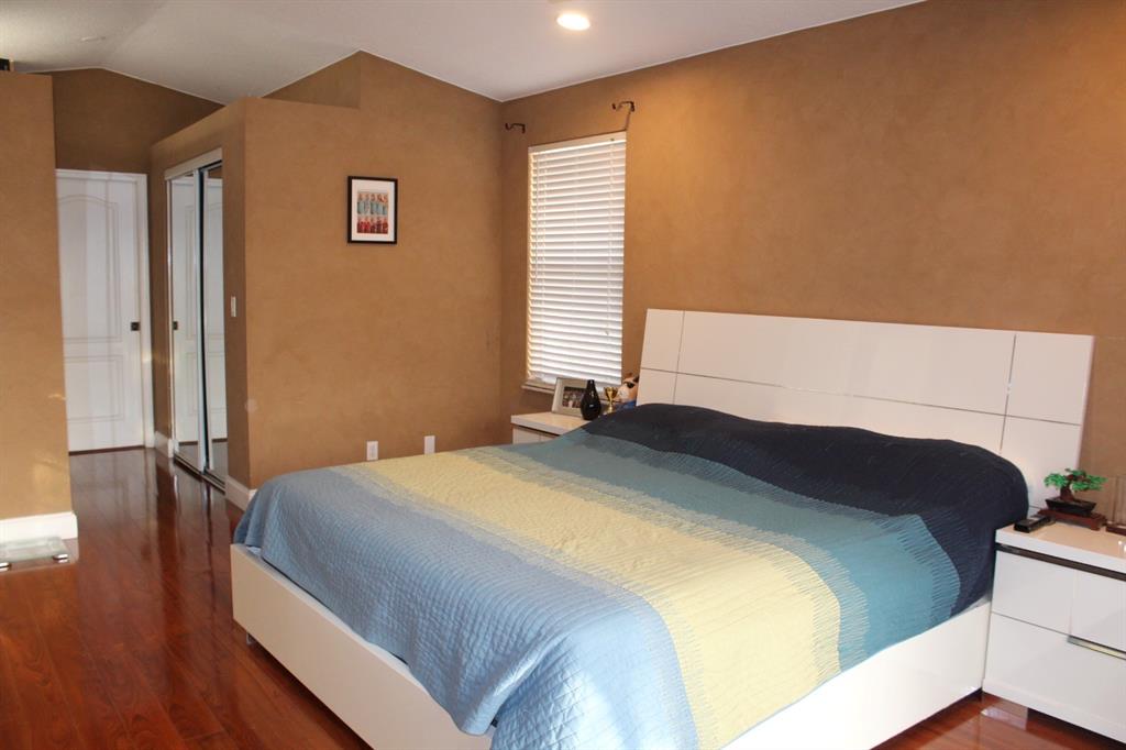 1512 Southwest 187th Terrace Pembroke Pines, FL 33029 - Photo 20 of 29 a bedroom with a bed and wooden floor