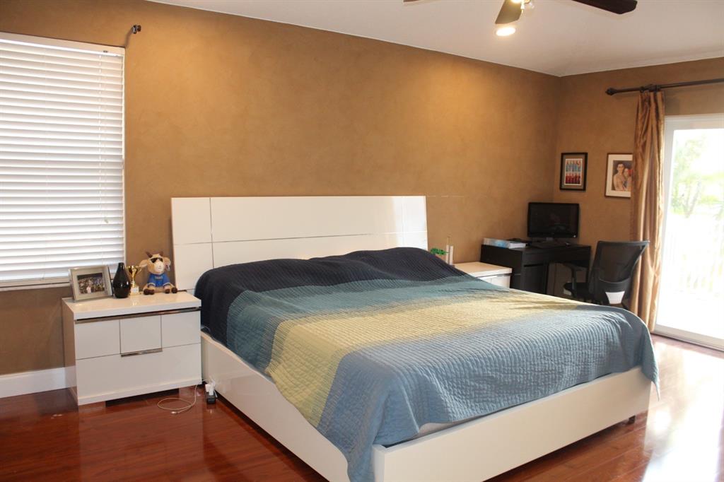 1512 Southwest 187th Terrace Pembroke Pines, FL 33029 - Photo 21 of 29 a bedroom with a bed and a lamp