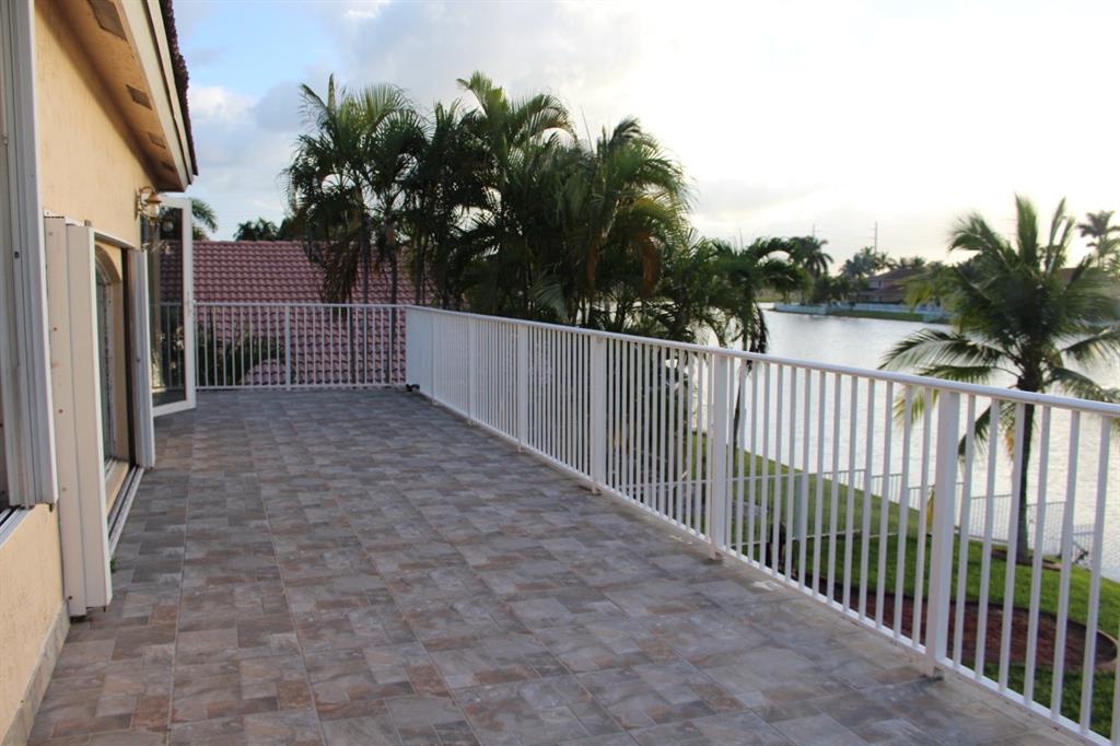 1512 Southwest 187th Terrace Pembroke Pines, FL 33029 - Photo 22 of 29 a view of a house with a small yard and wooden fence