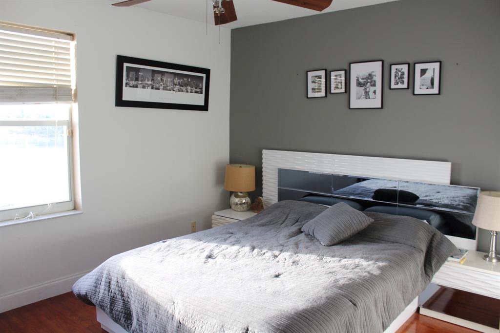 1512 Southwest 187th Terrace Pembroke Pines, FL 33029 - Photo 23 of 29 a bedroom with a bed and chair