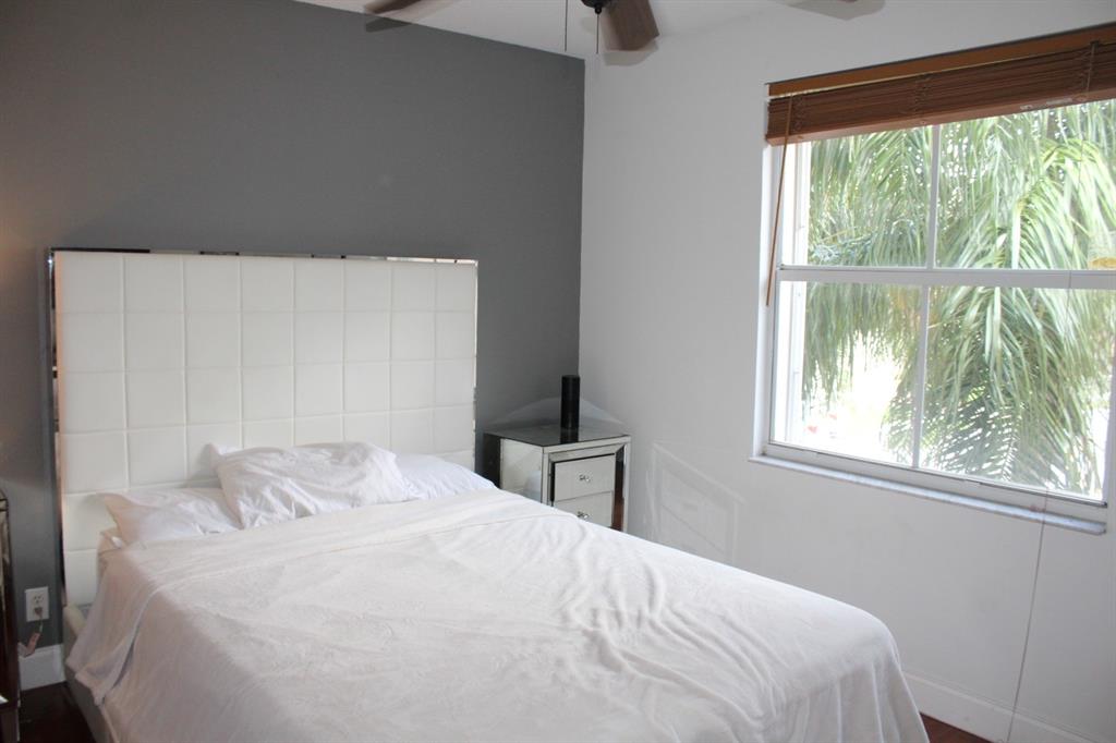 1512 Southwest 187th Terrace Pembroke Pines, FL 33029 - Photo 27 of 29 a bedroom with a bed and a large window