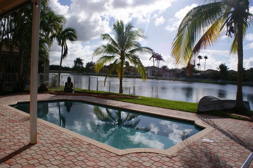 1512 Southwest 187th Terrace Pembroke Pines, FL 33029 - Photo 29 of 29 a view of swimming pool with a table and chairs