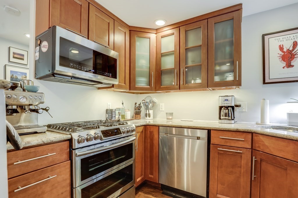 154 West 3rd Street, Unit 154 Boston, MA 02127 - Photo 12 of 26 a kitchen with stainless steel appliances a stove microwave and sink