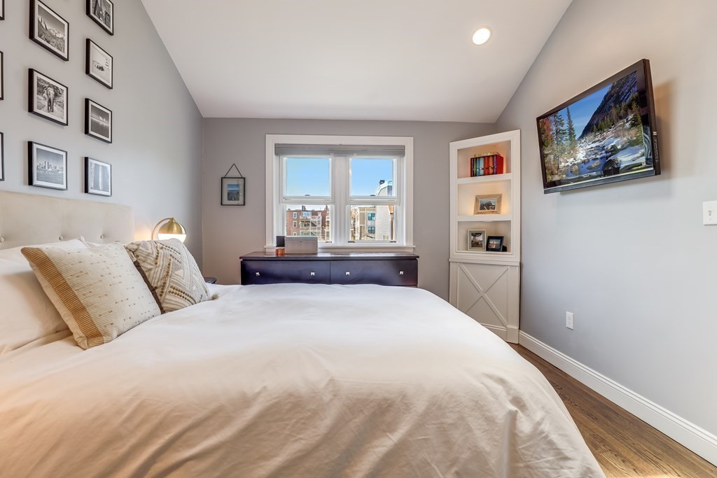 154 West 3rd Street, Unit 154 Boston, MA 02127 - Photo 18 of 26 a bedroom with a large bed and a painting on the wall