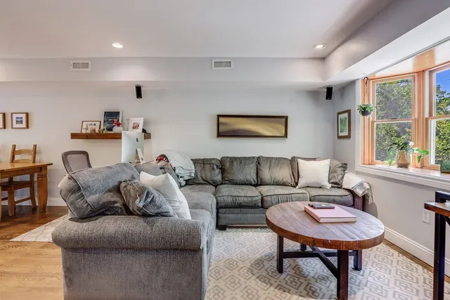 a living room with furniture a large window and a flat screen tv