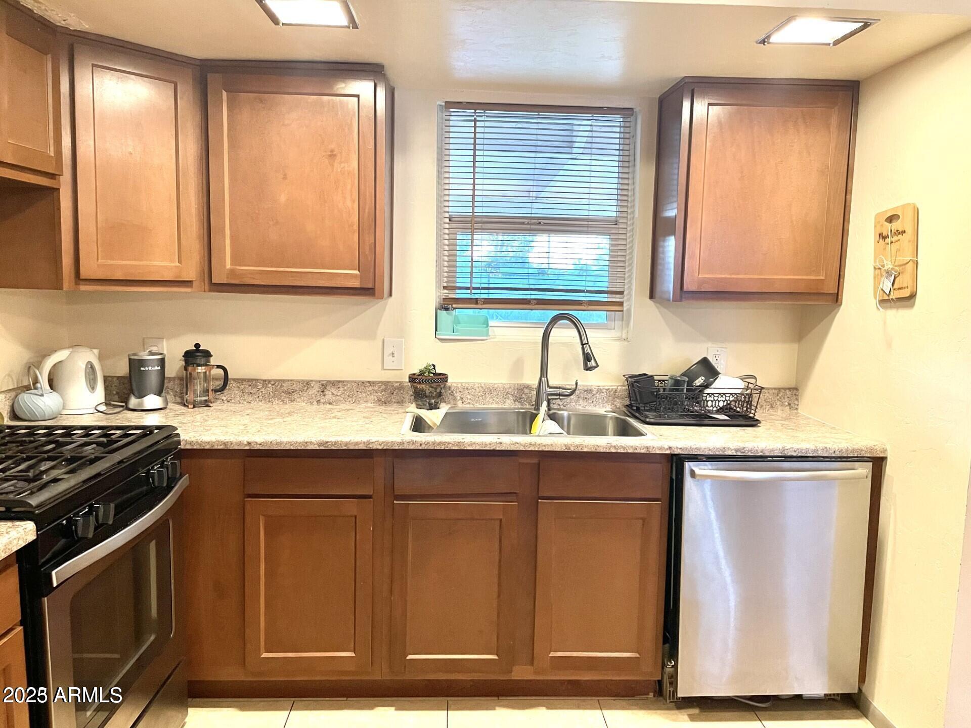 2454 East 14th Street Douglas, AZ 85607 - Photo 3 of 12 a kitchen with stainless steel appliances granite countertop a sink stove and cabinets
